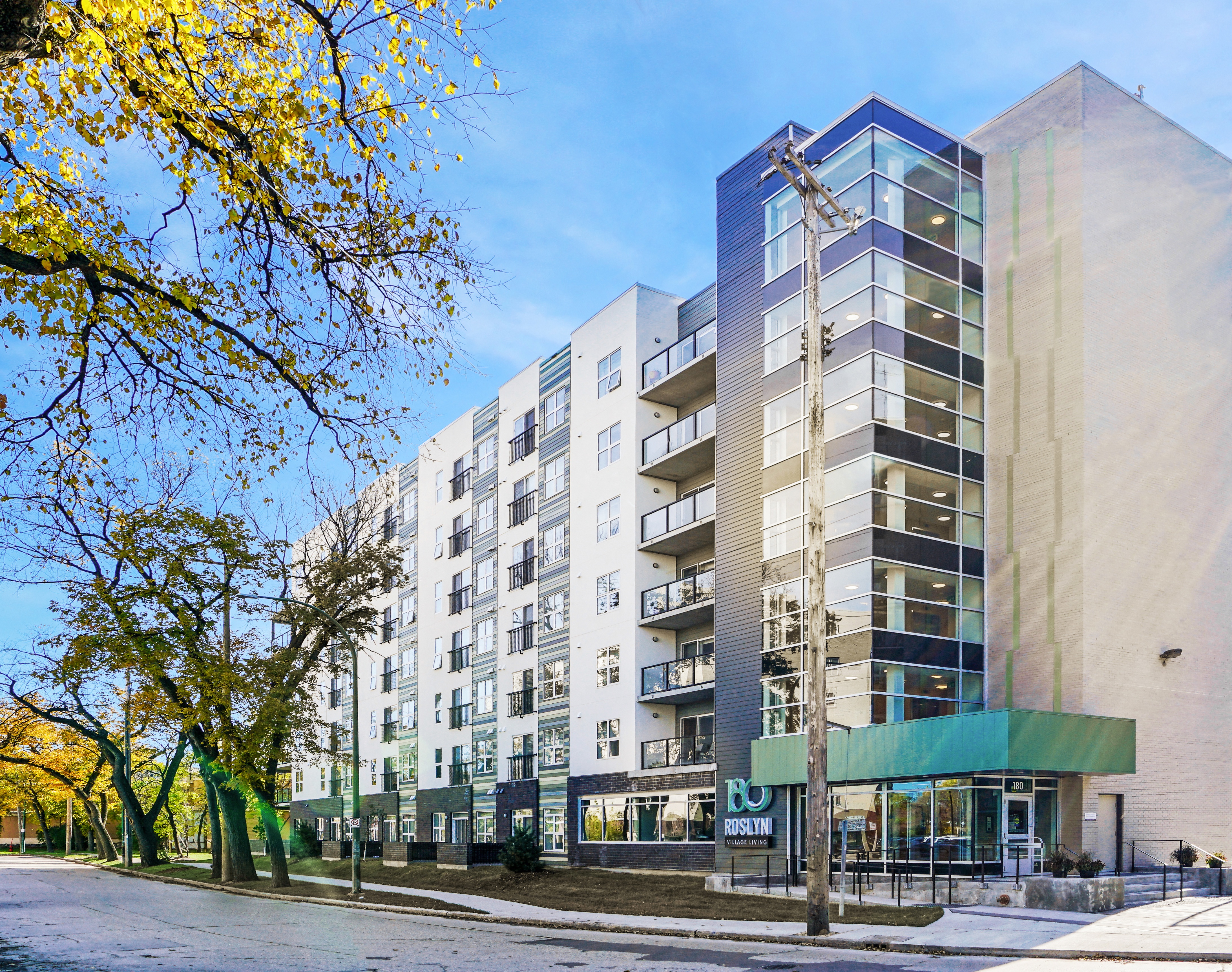 an apartment building with a street in front of it